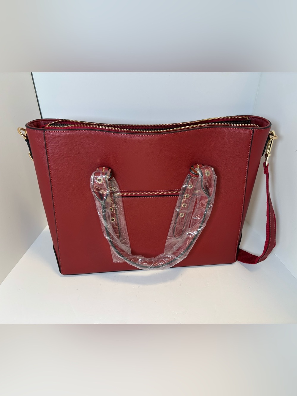 Red faux leather tote bag with gold hardware by Ease Gave